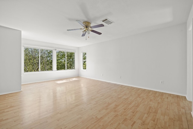 empty room featuring ceiling fan and light hardwood / wood-style flooring