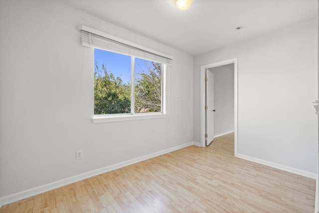 empty room with light hardwood / wood-style flooring