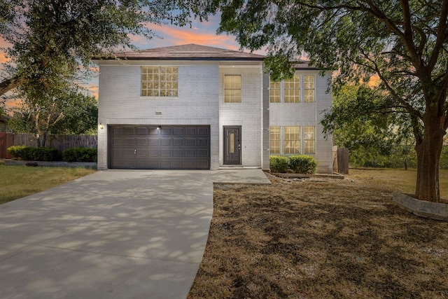 view of front of property with a lawn and a garage