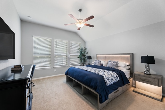 bedroom featuring ceiling fan, lofted ceiling, and light colored carpet