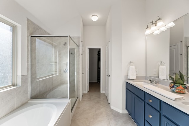 bathroom with independent shower and bath, vanity, and tile patterned flooring