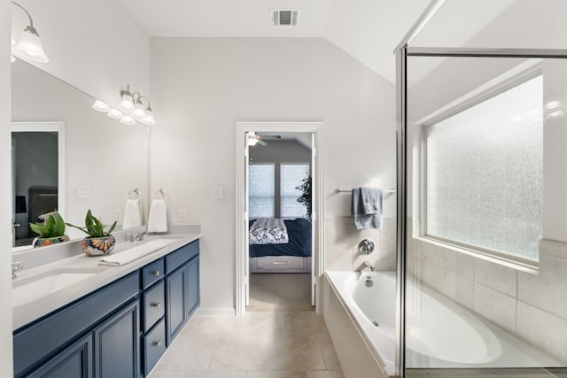 bathroom with lofted ceiling, tile patterned flooring, a washtub, vanity, and ceiling fan