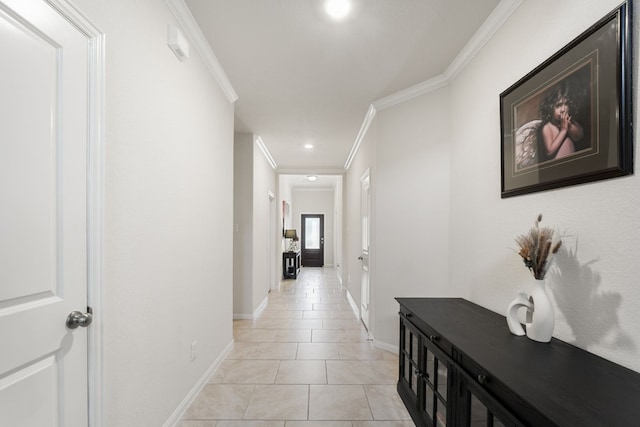 corridor with ornamental molding and light tile patterned flooring