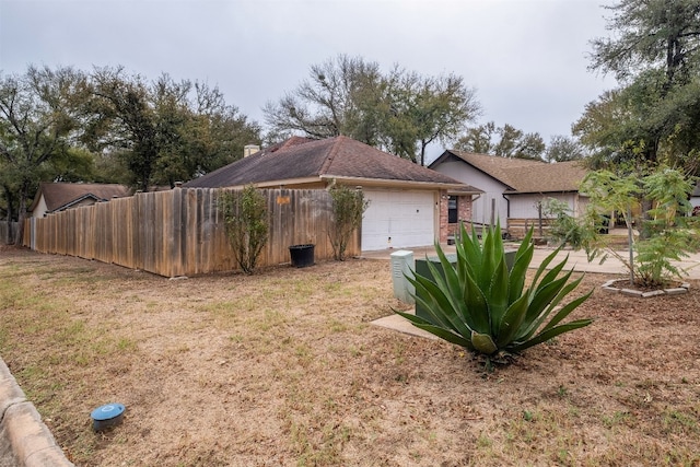 view of home's exterior with a lawn and a garage