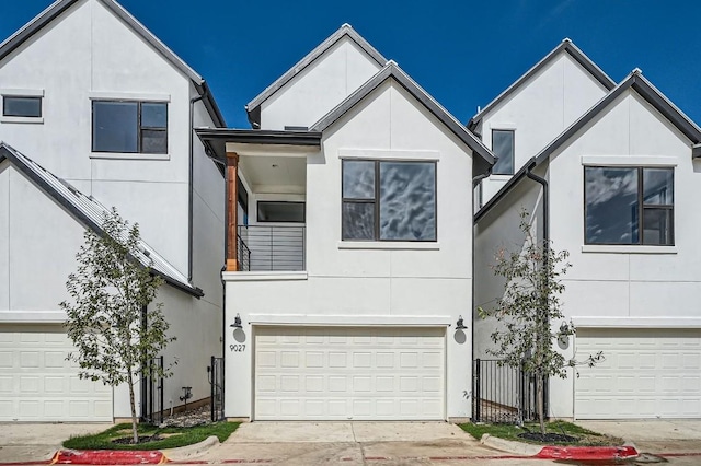 9027 Cattle Baron Path, Austin, TX 78747 - view of front facade with stucco siding, an attached garage, and driveway