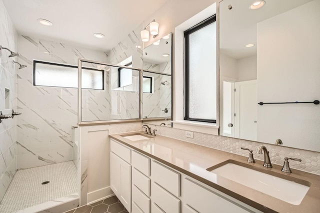 9027 Cattle Baron Path, Austin, TX 78747 - bathroom featuring a marble finish shower, double vanity, recessed lighting, and tasteful backsplash