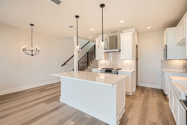 9027 Cattle Baron Path, Austin, TX 78747 - kitchen featuring wall chimney exhaust hood, appliances with stainless steel finishes, light wood-style flooring, backsplash, and recessed lighting