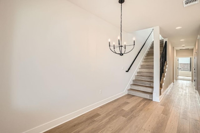9027 Cattle Baron Path, Austin, TX 78747 - stairway with wood finished floors, a chandelier, and recessed lighting