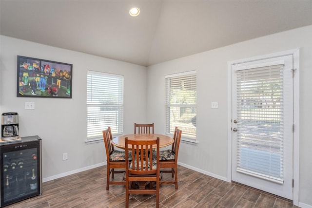 4303 Lindberg Ln, Lago Vista, TX 78645 - dining area with wine cooler, dark wood-style floors, vaulted ceiling, baseboards, and recessed lighting