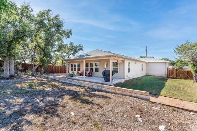 rear view of house with a patio area and a lawn