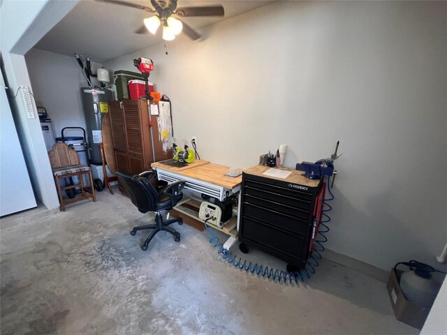 office area featuring concrete floors, ceiling fan, and water heater