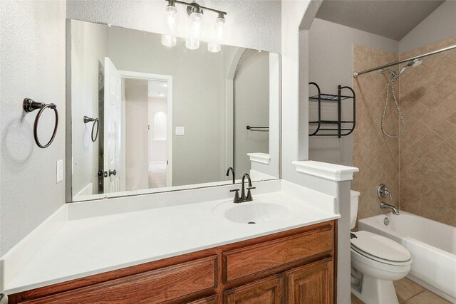 full bathroom featuring tile patterned flooring, vanity, toilet, and tiled shower / bath