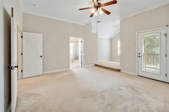 interior space featuring vaulted ceiling, light carpet, ceiling fan, and crown molding