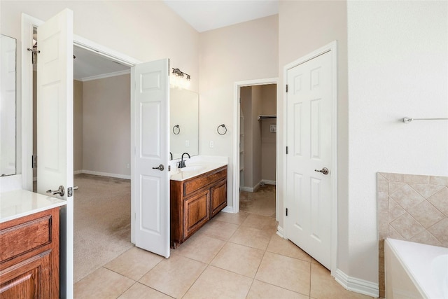 bathroom with a bathing tub, tile patterned flooring, and vanity