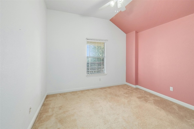 carpeted spare room featuring lofted ceiling and ceiling fan