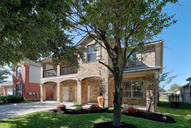 view of front of property featuring a front lawn and a balcony