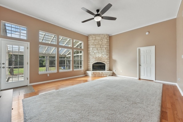 unfurnished living room with ornamental molding, plenty of natural light, and light hardwood / wood-style floors