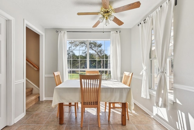 tiled dining area with ceiling fan