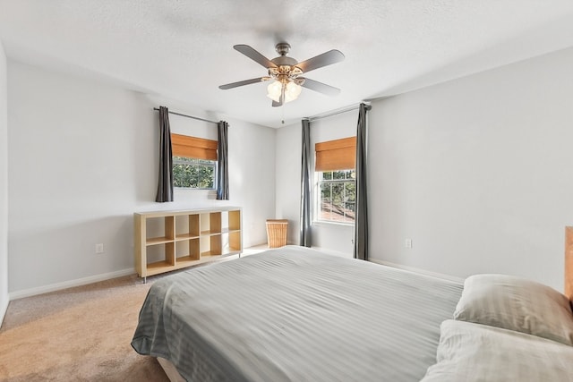 carpeted bedroom with a textured ceiling and ceiling fan