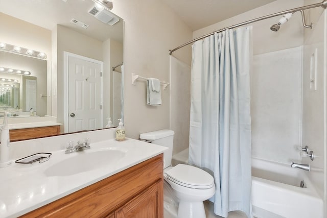 full bathroom featuring vanity, shower / bath combination with curtain, and toilet