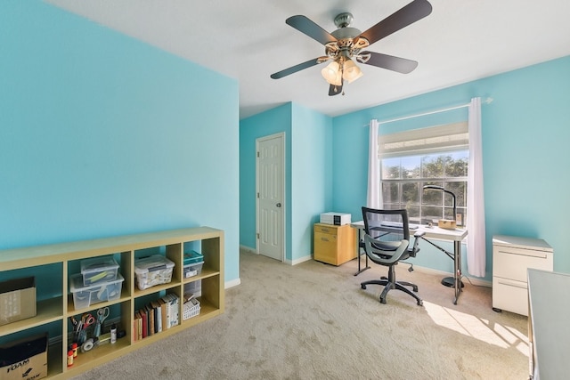 home office featuring ceiling fan and light colored carpet