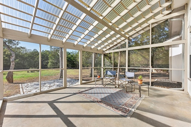 unfurnished sunroom with lofted ceiling