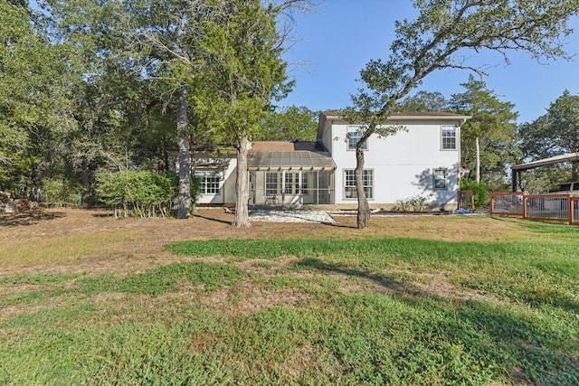 back of property with a yard and a patio area