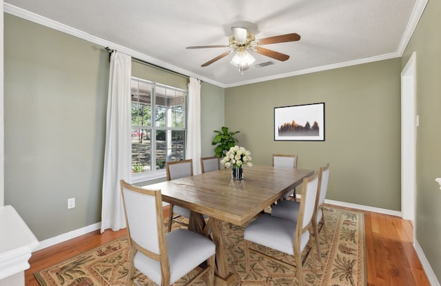 dining area featuring ceiling fan, light hardwood / wood-style flooring, and crown molding