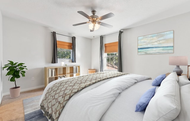 carpeted bedroom with a textured ceiling and ceiling fan