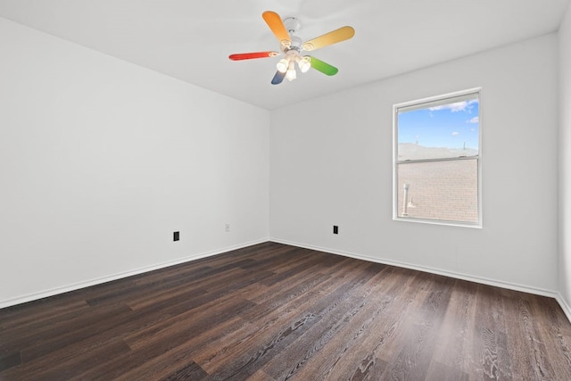 spare room with ceiling fan and dark hardwood / wood-style floors