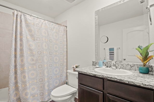 full bathroom with shower / bath combo, vanity, and toilet