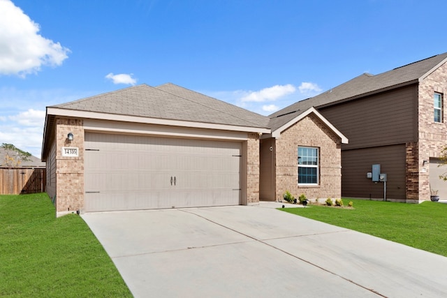 view of front of property featuring a garage and a front lawn