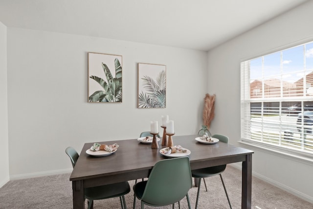 dining room with plenty of natural light and light colored carpet