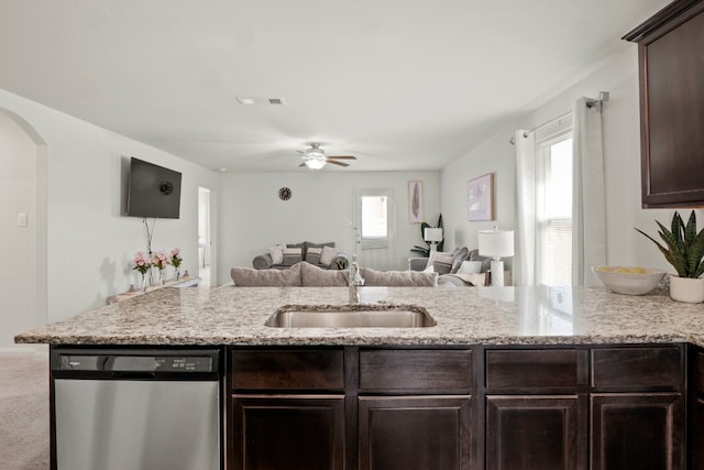 kitchen featuring stainless steel dishwasher, light carpet, plenty of natural light, and sink