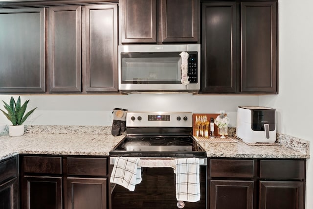 kitchen featuring dark brown cabinetry and stainless steel appliances