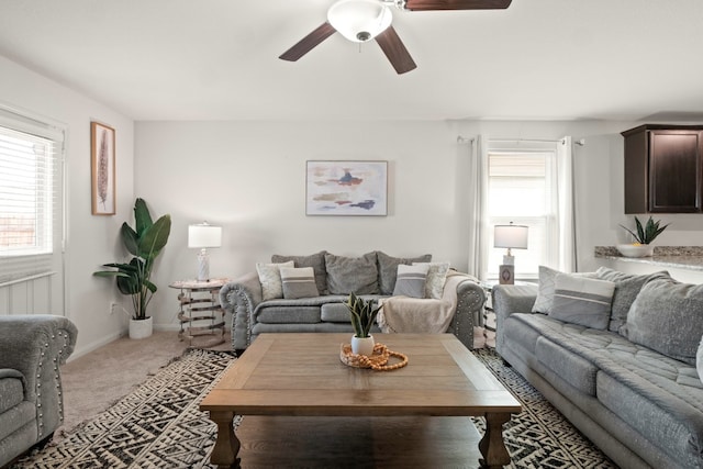 carpeted living room with ceiling fan