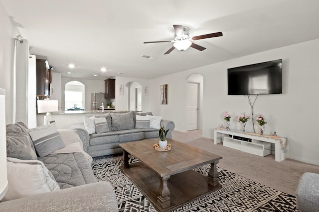 living room with light carpet and ceiling fan