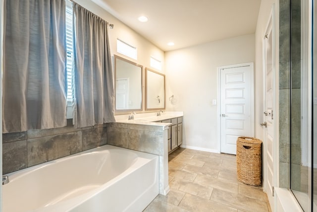 bathroom featuring a wealth of natural light, vanity, and plus walk in shower