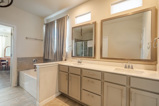 bathroom with tile patterned flooring, vanity, and separate shower and tub