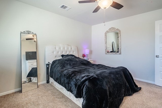 bedroom with ceiling fan and light colored carpet