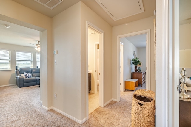 corridor with light colored carpet