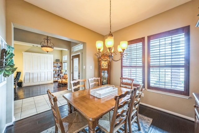 dining space featuring dark hardwood / wood-style floors and a chandelier