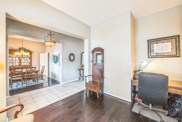 office area with hardwood / wood-style flooring and an inviting chandelier