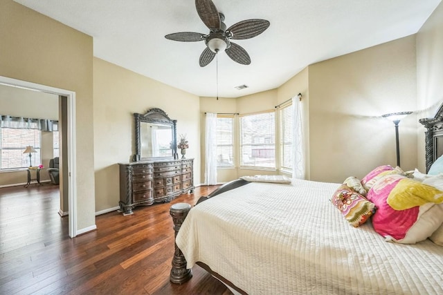 bedroom with dark hardwood / wood-style floors and ceiling fan