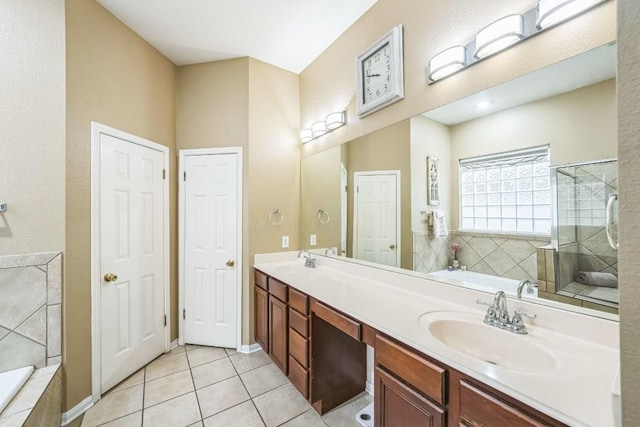 bathroom with tile patterned flooring, vanity, and plus walk in shower