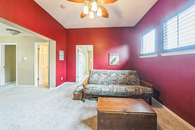 living area featuring carpet floors and ceiling fan