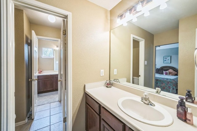 bathroom with vanity, tile patterned floors, and toilet