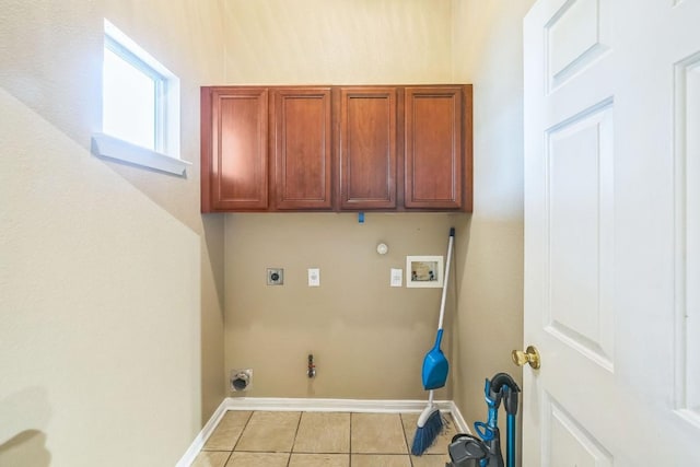 laundry room featuring cabinets, light tile patterned floors, hookup for a washing machine, electric dryer hookup, and hookup for a gas dryer