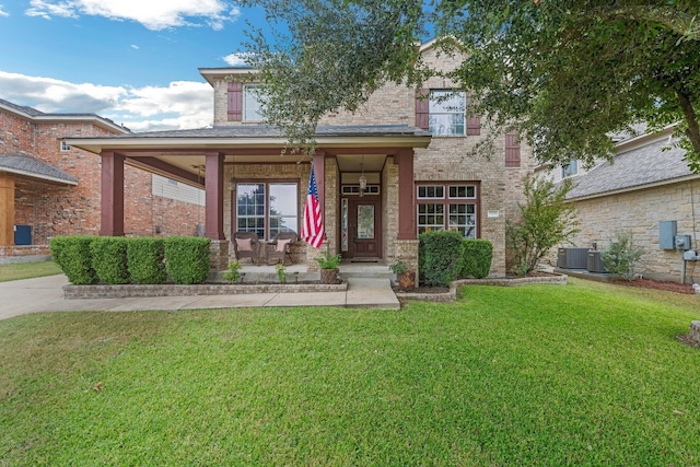 view of front of house with a front yard and central air condition unit