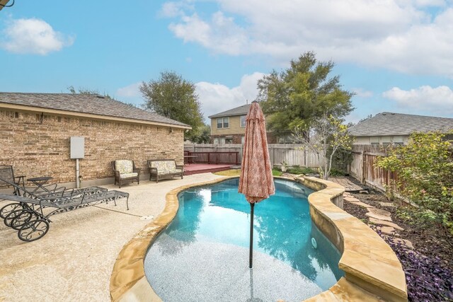 view of swimming pool with a patio